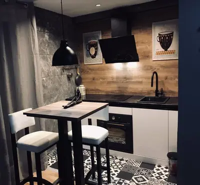 a kitchen with a table and chairs and a sink at Bubinga in Kruševac