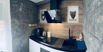 a kitchen with a counter top with a microwave at Bubinga in Kruševac