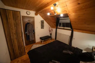 a bedroom with a bed and a wooden ceiling at Vila Jezerski raj Borsko jezero in Bor