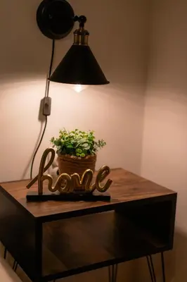 a table with a lamp and a plant on it at Vila Jezerski raj Borsko jezero in Bor