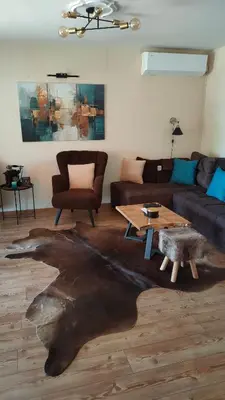 a living room with a couch and a table at Vila Jezerski raj Borsko jezero in Bor