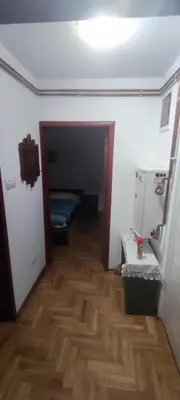 a hallway with a room with a wooden floor and a door at Apartmani Sovica in Vrnjačka Banja