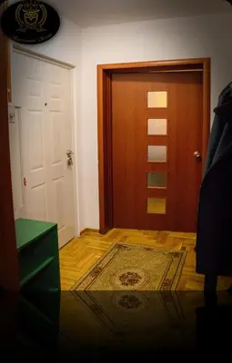 a room with a door and a rug and a door at Apartmani Sovica in Vrnjačka Banja