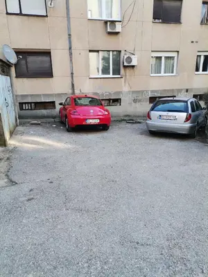 two cars parked in a parking lot in front of a building at STAN na DAN PEX FREE PARKING in Vranje