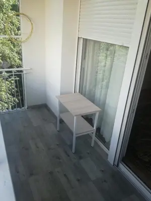 a small table sitting on the porch of a house at STAN na DAN PEX FREE PARKING in Vranje