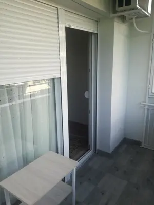 a door to a room with a window and a bench at STAN na DAN PEX FREE PARKING in Vranje