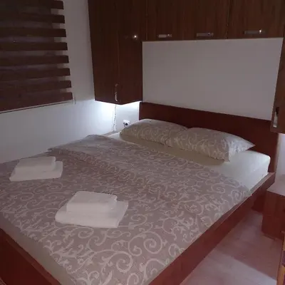 a bed with two white towels on top of it at Apartman Alba in Kopaonik