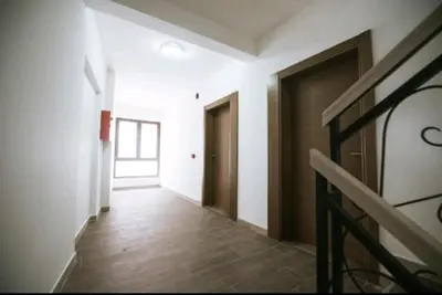 an empty hallway with a door and a staircase at Apartman Alba in Kopaonik