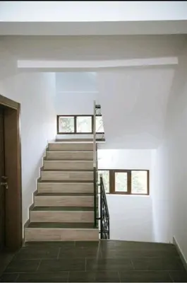 a staircase in a house with white walls at Apartman Alba in Kopaonik