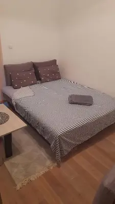 a large bed sitting on the floor in a room at Apartman TiA Vrnjacka Banja in Vrnjačka Banja