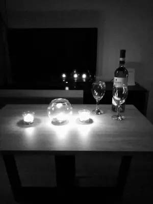 a table with two glasses and a bottle of wine at Apartman TiA Vrnjacka Banja in Vrnjačka Banja