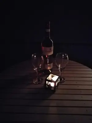 a bottle of wine and two glasses on a table at Apartman TiA Vrnjacka Banja in Vrnjačka Banja