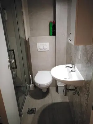 a bathroom with a toilet and a sink and a shower at Apartman TiA Vrnjacka Banja in Vrnjačka Banja