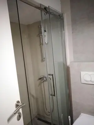 a shower with a glass door in a bathroom at Apartman TiA Vrnjacka Banja in Vrnjačka Banja