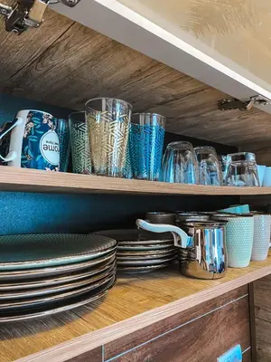 a shelf with plates and glasses on it at Milmari MM L24 in Kopaonik