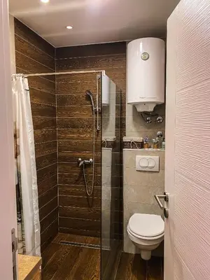 a bathroom with a toilet and a glass shower at Milmari MM L24 in Kopaonik