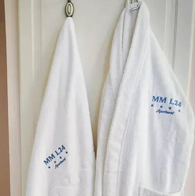 two white towels hanging on a wall at Milmari MM L24 in Kopaonik