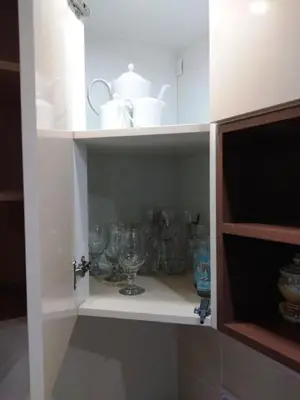 a cabinet filled with glasses and china at Kopaonik,Sunčana dolina,Apart-Pavlovic in Kopaonik