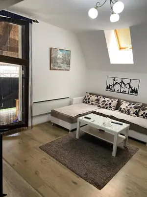 a living room with a couch and a table at Kopaonik,Sunčana dolina,Apart-Pavlovic in Kopaonik