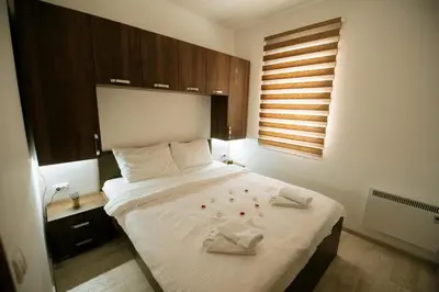 a bedroom with a bed with two towels on it at Apartman Kostic Kraljev Konak in Kopaonik