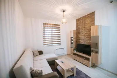 a living room with a couch and a tv at Apartman Kostic Kraljev Konak in Kopaonik