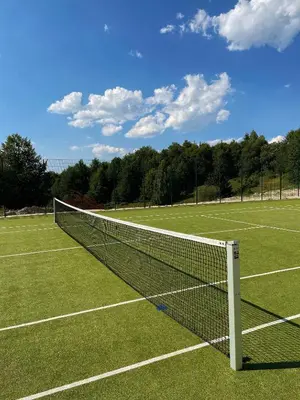 a tennis net on a grass tennis court at Apartman Kostic Kraljev Konak in Kopaonik