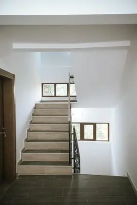 a staircase in a house with white walls at Apartman Ema in Kopaonik