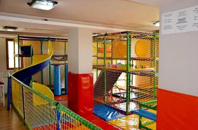 a play room with a slide and a playground at Dream Milmari L12 Apartman in Kopaonik