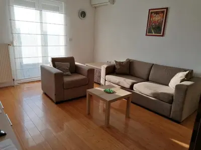 a living room with two couches and a coffee table at Apartman Breza in Kruševac