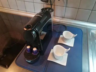 a blow dryer sitting on a counter with cups at Apartman Breza in Kruševac