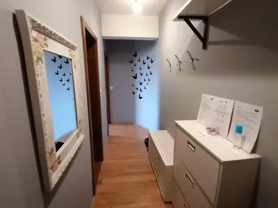a room with a mirror on the wall and a dresser at Apartman Breza in Kruševac