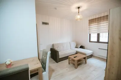 a living room with a couch and a table at Kraljevi Konaci -Apartmani Bajka in Kopaonik