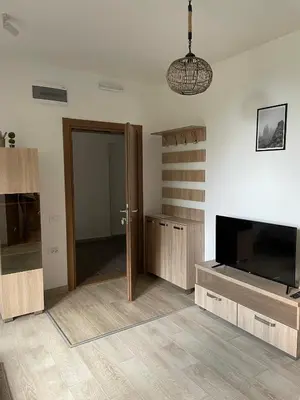 a living room with a door and a tv and a room with a tvicter at Kraljevi Konaci -Apartmani Bajka in Kopaonik