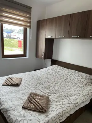 a bedroom with a bed with two towels on it at Kraljevi Konaci -Apartmani Bajka in Kopaonik