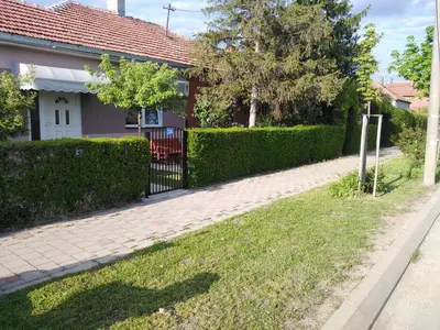 a house with a fence and a brick driveway at APARTMAN “POD KRALJEVICOM” in Zaječar