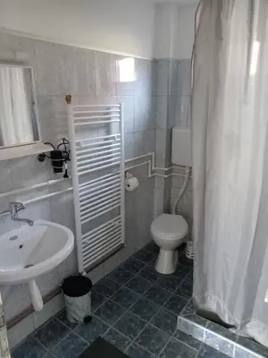 a bathroom with a white sink and a toilet at APARTMAN “POD KRALJEVICOM” in Zaječar