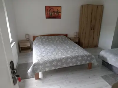 a bedroom with a bed with a blanket on it at APARTMAN “POD KRALJEVICOM” in Zaječar