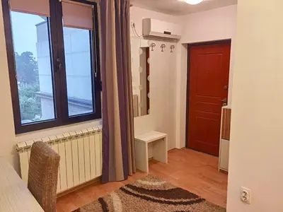 a room with a large window and a door at Alo Alo Apartman 6 in Kruševac