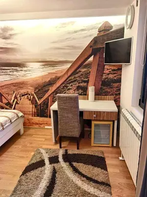 a room with a wall mural of a lighthouse at Alo Alo Apartman 6 in Kruševac