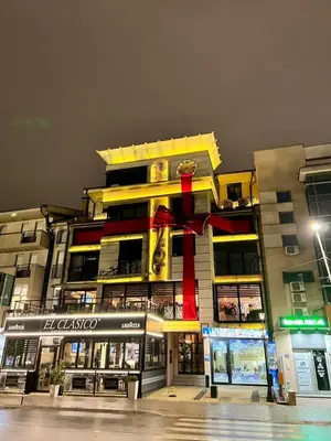 a large building with a red ribbon on it at Alo Alo Apartman 6 in Kruševac