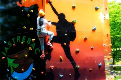 a mural of a woman on a climbing wall at Idila in Kruševac