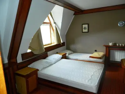 two beds in a room with a window at Idila in Kruševac