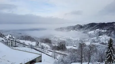 a view of a snow covered valley with a mountain at MIPS Milmari Resort Kopaonik in Kopaonik