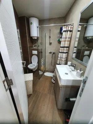 a bathroom with a toilet and a sink and a shower at MIPS Milmari Resort Kopaonik in Kopaonik