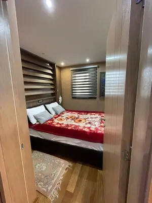 a bedroom with a bed with a red comforter at Vila PAHULJA A6 in Kopaonik
