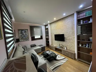 a living room with a couch and a tv at Vila PAHULJA A6 in Kopaonik