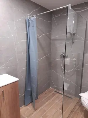 a shower with a glass door in a bathroom at Prezident Marta in Kopaonik