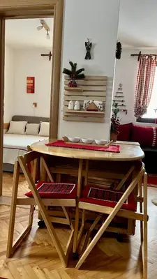 a table in a room with a living room at Vila Boris, Apartman Aleksej - Kopaonik in Kopaonik