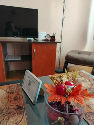 a vase filled with fruit on a glass table at Apartman Domina in Kruševac