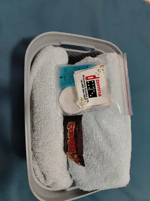 a suitcase filled with towels and a bar of chocolate at Apartman Domina in Kruševac